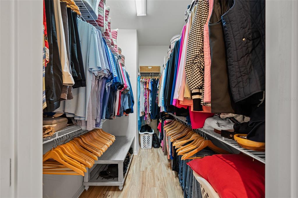 6377 Southwest 88th Terrace Gainesville, FL 32608 - Photo 19 of 37 a view of walk in closet with clothes and shoes