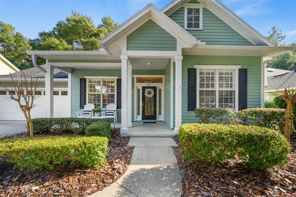 6377 Southwest 88th Terrace Gainesville, FL 32608 - Photo 2 of 37 a front view of a house with garden