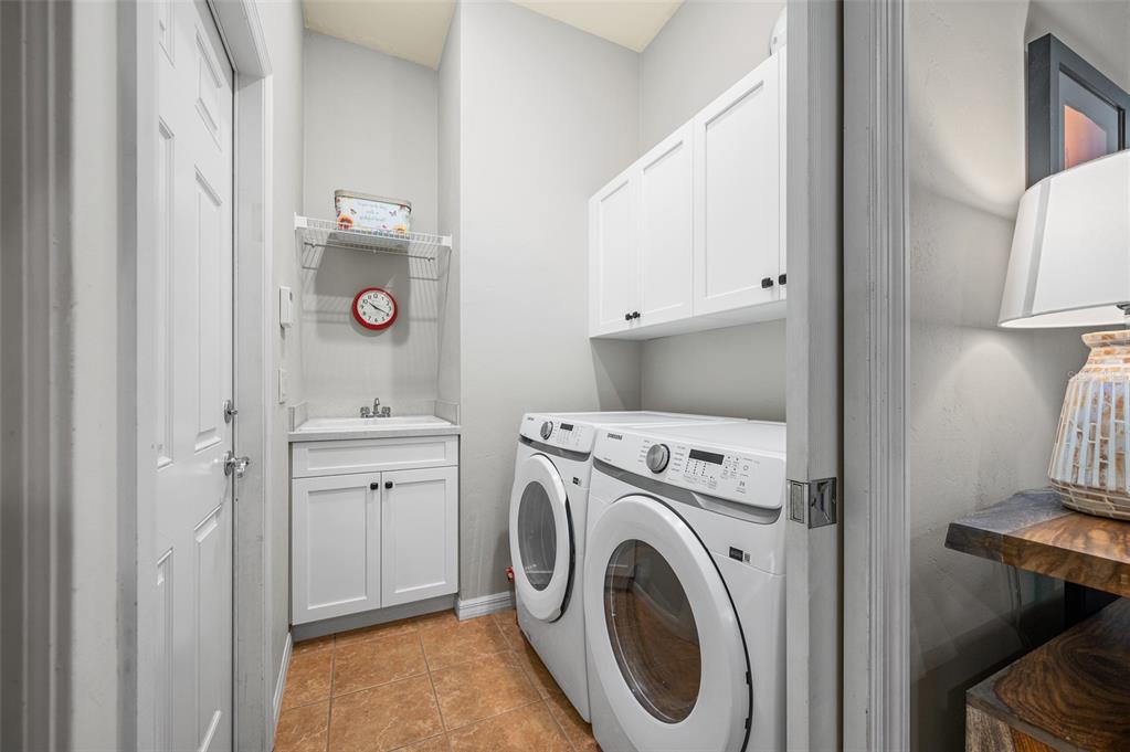 6377 Southwest 88th Terrace Gainesville, FL 32608 - Photo 30 of 37 a view of washer and dryer with bathroom in the background