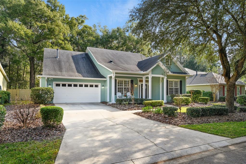 6377 Southwest 88th Terrace Gainesville, FL 32608 - Photo 37 of 37 a view of a house with a yard plants and large tree