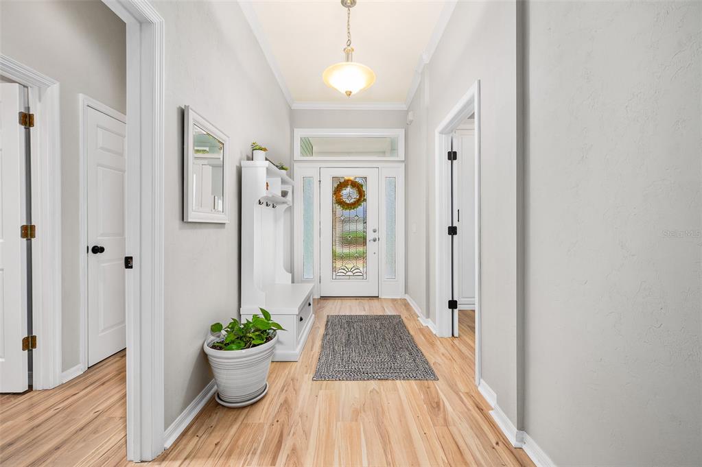 6377 Southwest 88th Terrace Gainesville, FL 32608 - Photo 4 of 37 a view of a hallway with wooden floor and front door