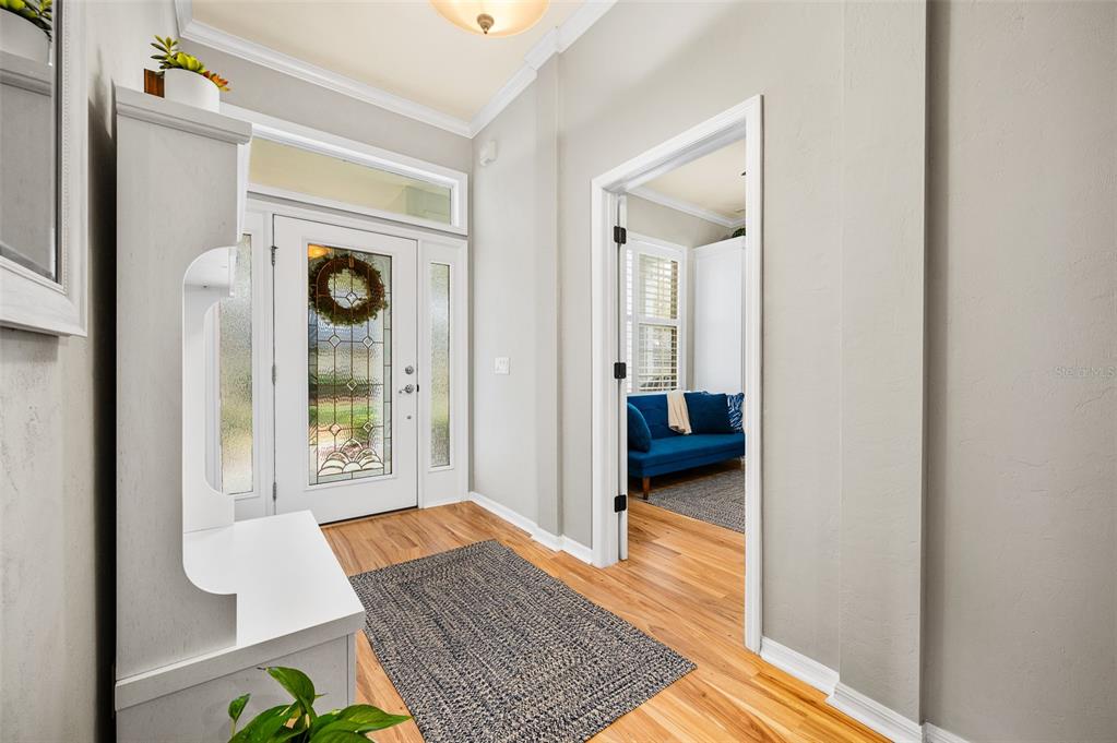 6377 Southwest 88th Terrace Gainesville, FL 32608 - Photo 5 of 37 a view of a hallway with wooden floor and a livingroom