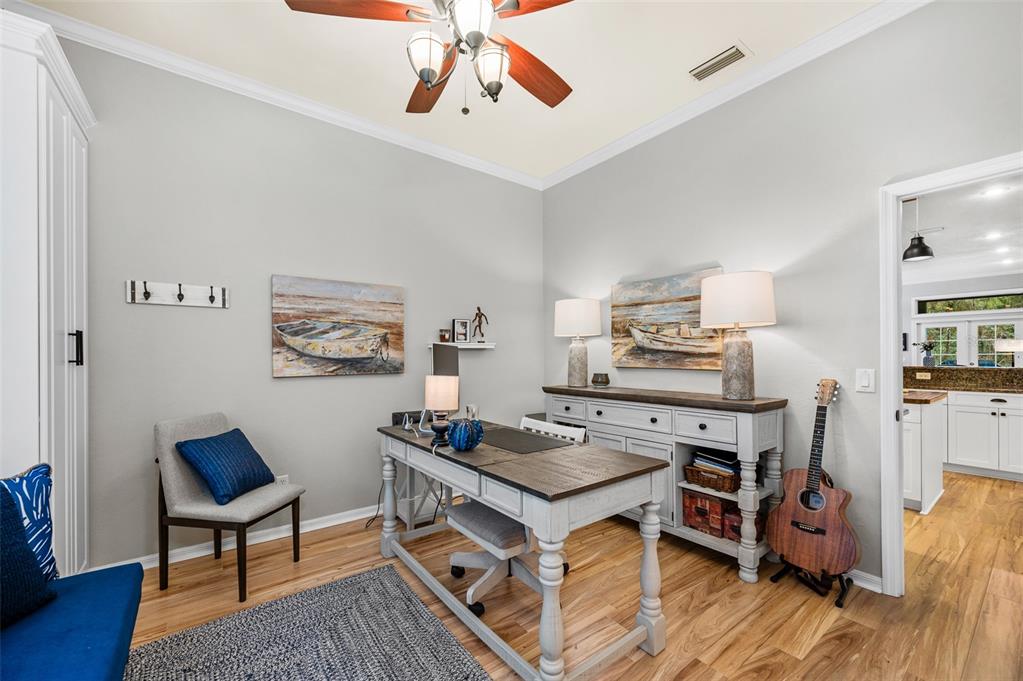 6377 Southwest 88th Terrace Gainesville, FL 32608 - Photo 7 of 37 a living room with furniture and a wooden floor