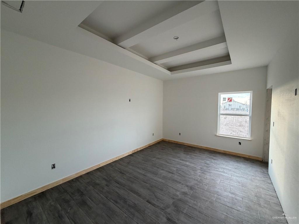 2292 Via Roma Road Weslaco, TX 78596 - Photo 3 of 10 a view of an empty room with wooden floor and a window