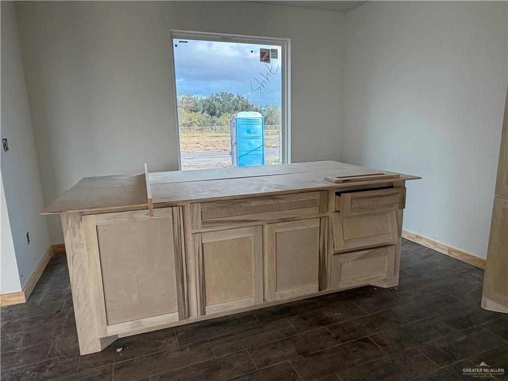 2292 Via Roma Road Weslaco, TX 78596 - Photo 6 of 10 a kitchen with granite countertop cabinets a window and a sink