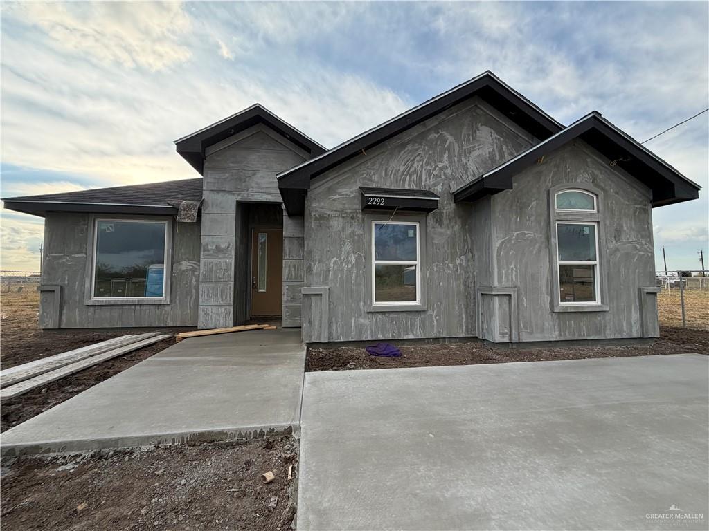 2292 Via Roma Road Weslaco, TX 78596 - Photo 9 of 10 a front view of a house with a yard and garage