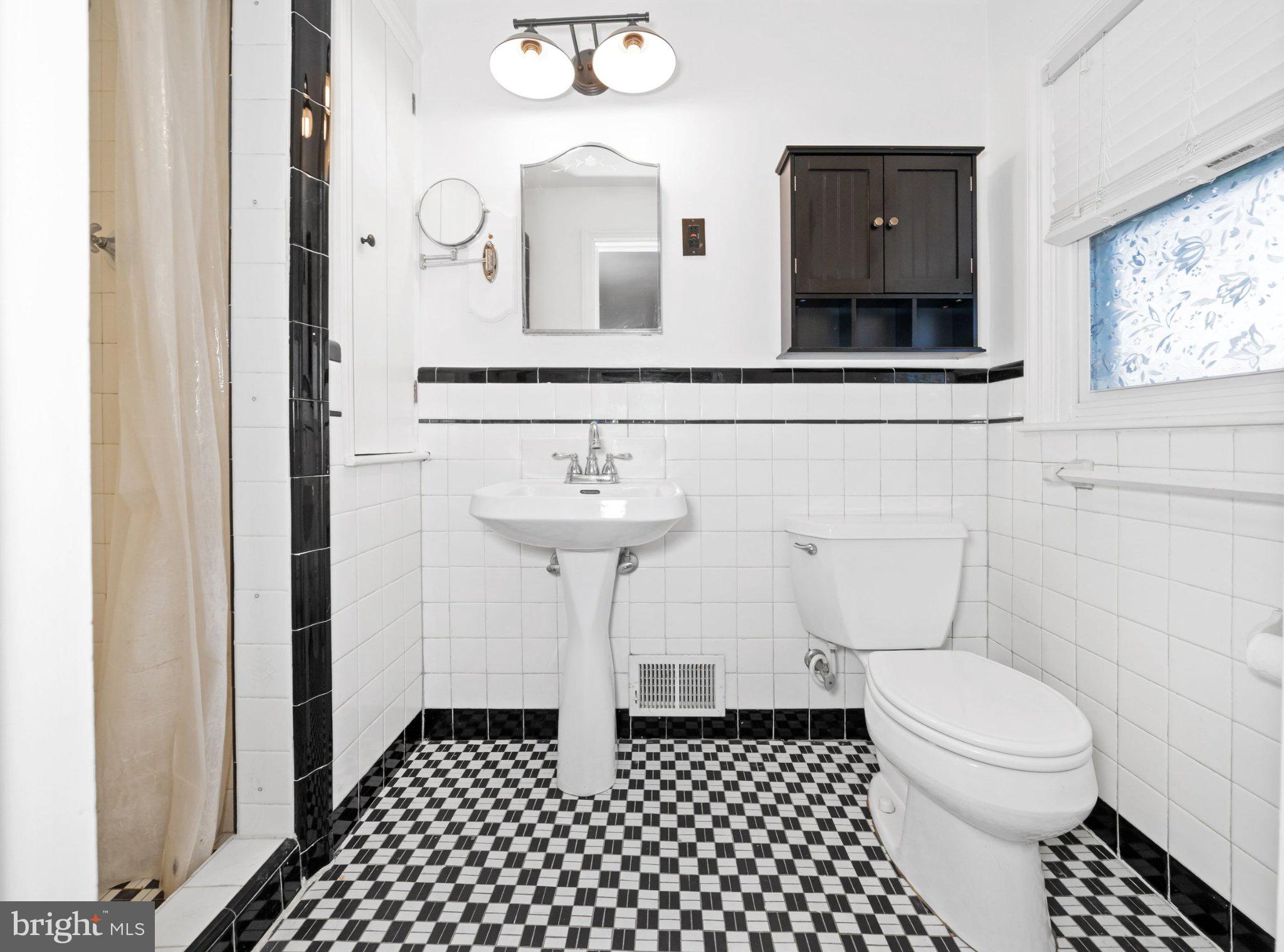 512 Lennox Road Wilmington, DE 19809 - Photo 18 of 28 Chic black-and-white bathroom retreat.