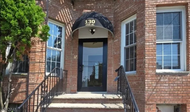 a view of a brick house with many windows