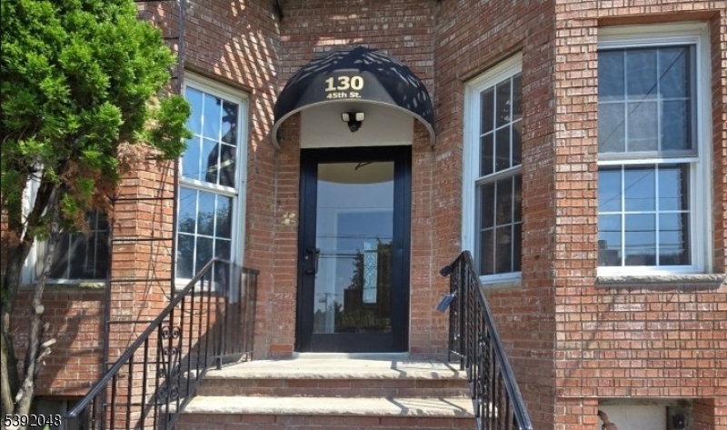 a view of a brick house with many windows