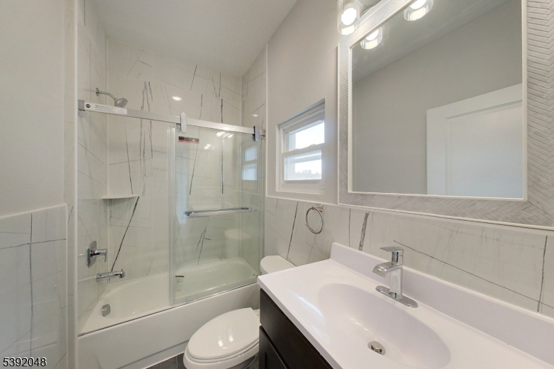 130 45th Street, Unit 2 Union City, NJ 07087 - Photo 16 of 16 a bathroom with a sink toilet and shower