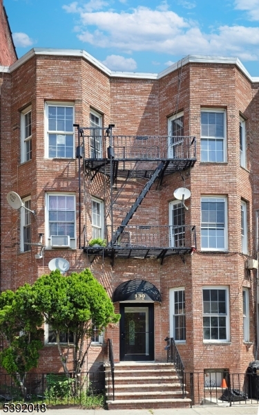 130 45th Street, Unit 2 Union City, NJ 07087 - Photo 2 of 16 a front view of a residential apartment building with a yard
