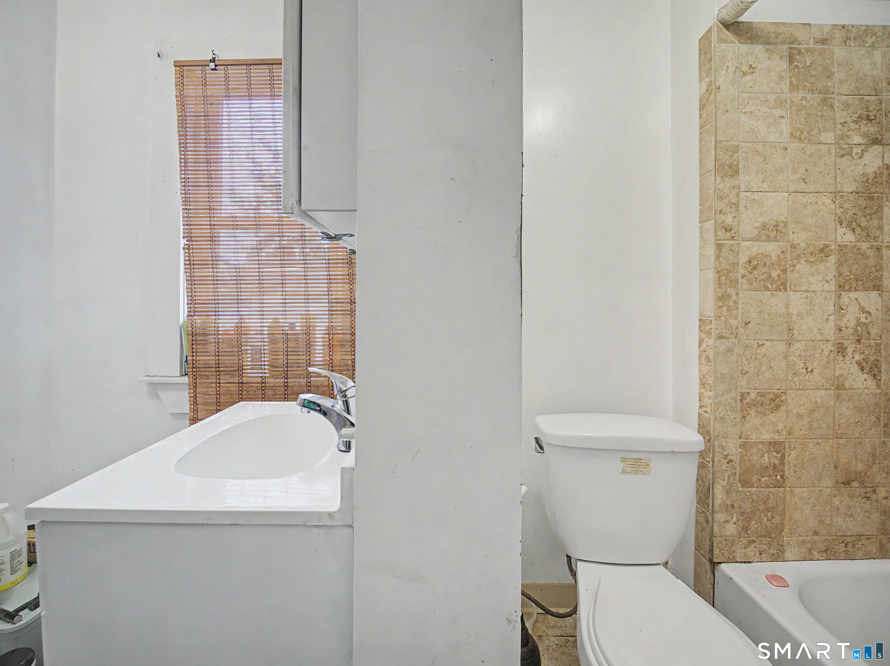 319 Carroll Avenue Bridgeport, CT 06607 - Photo 26 of 40 a white toilet sitting next to a bathroom sink