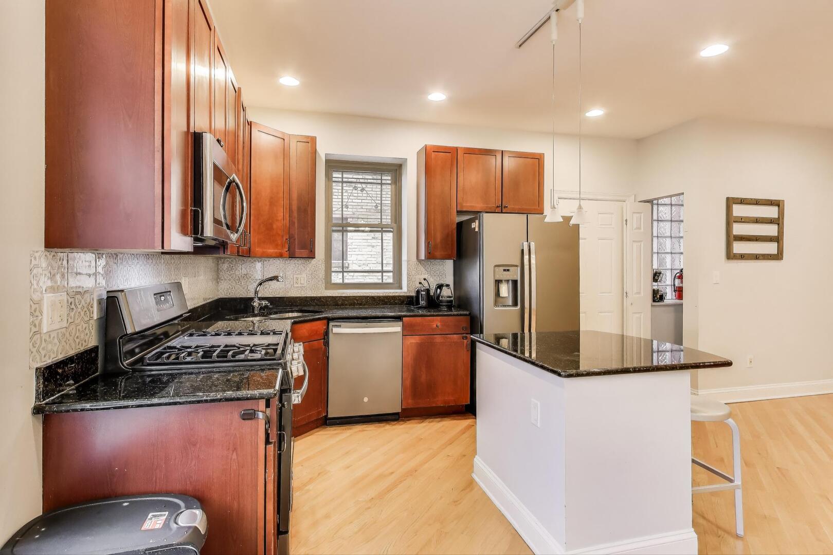 911 Maple Avenue, Unit 1N Evanston, IL 60202 - Photo 13 of 29 a kitchen with stainless steel appliances granite countertop a refrigerator stove and sink