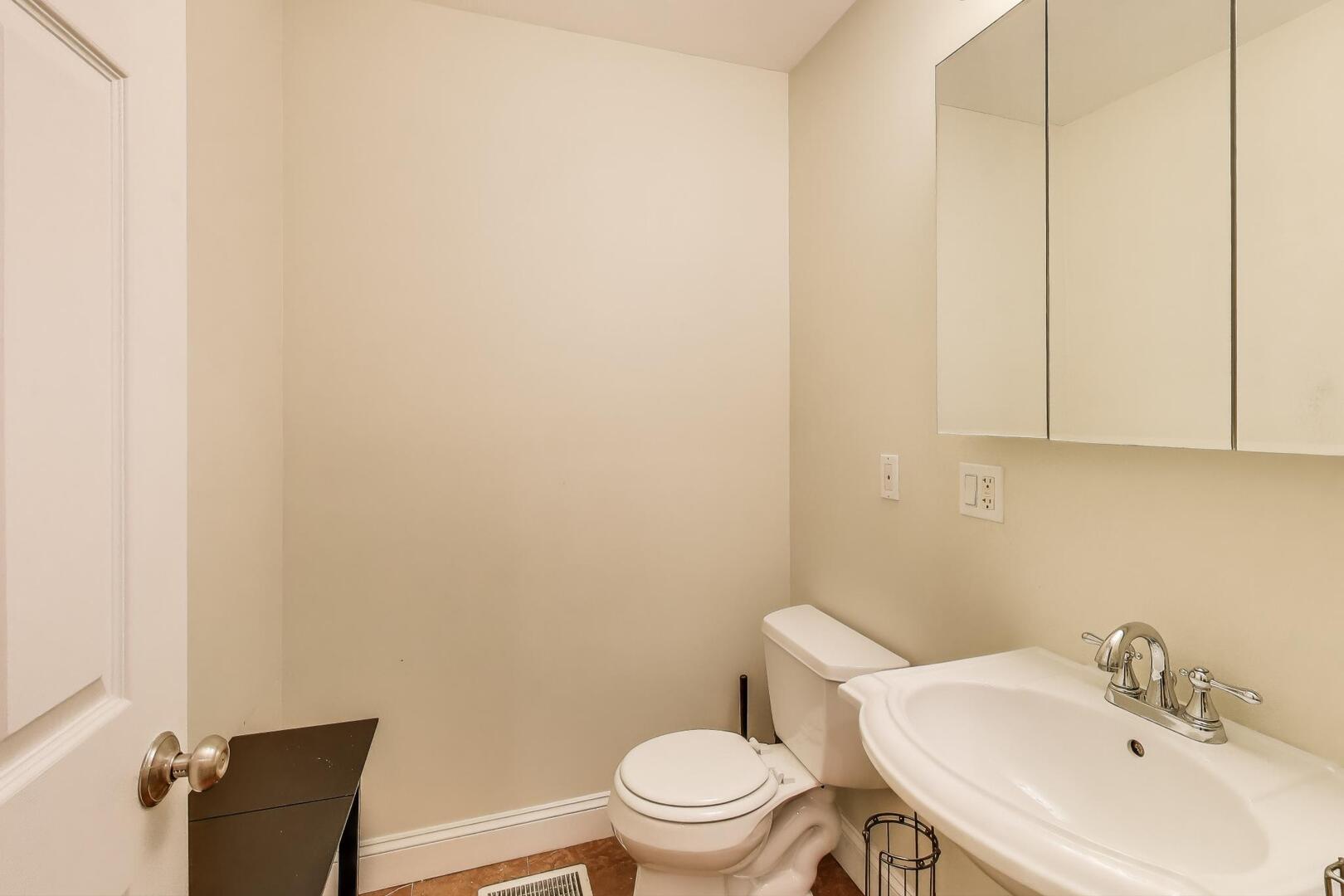 911 Maple Avenue, Unit 1N Evanston, IL 60202 - Photo 16 of 29 a bathroom with a sink a toilet and mirror
