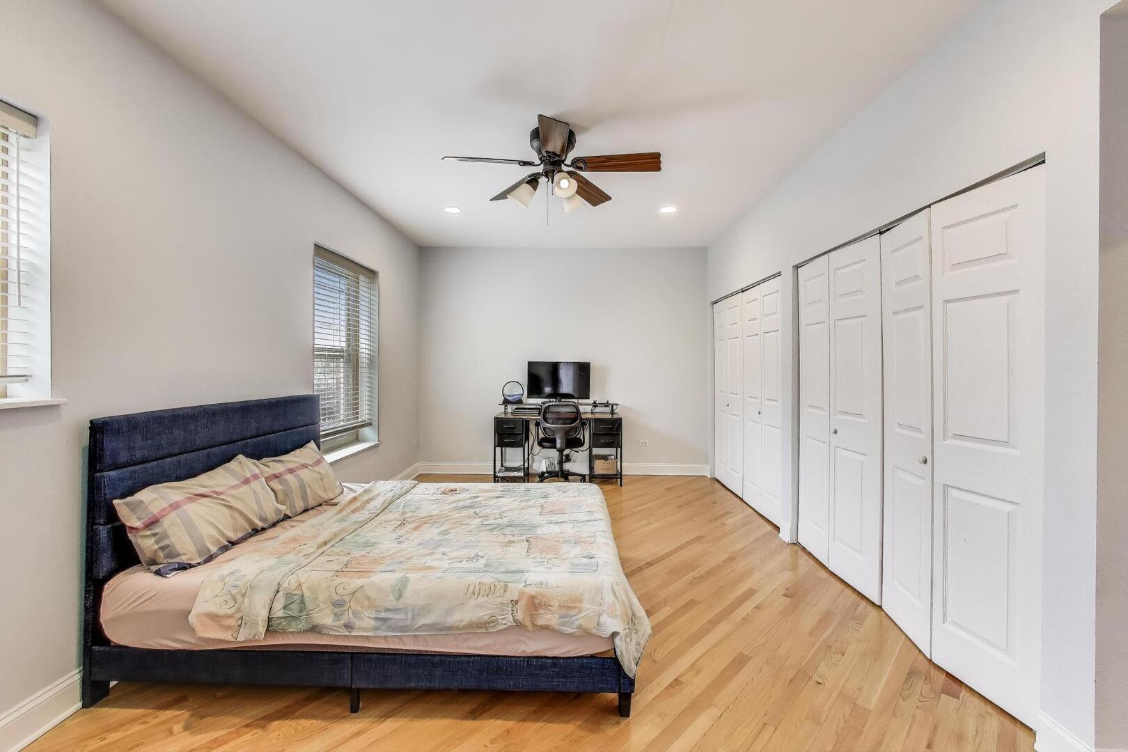 911 Maple Avenue, Unit 1N Evanston, IL 60202 - Photo 17 of 29 a bedroom with a large bed and a chandelier