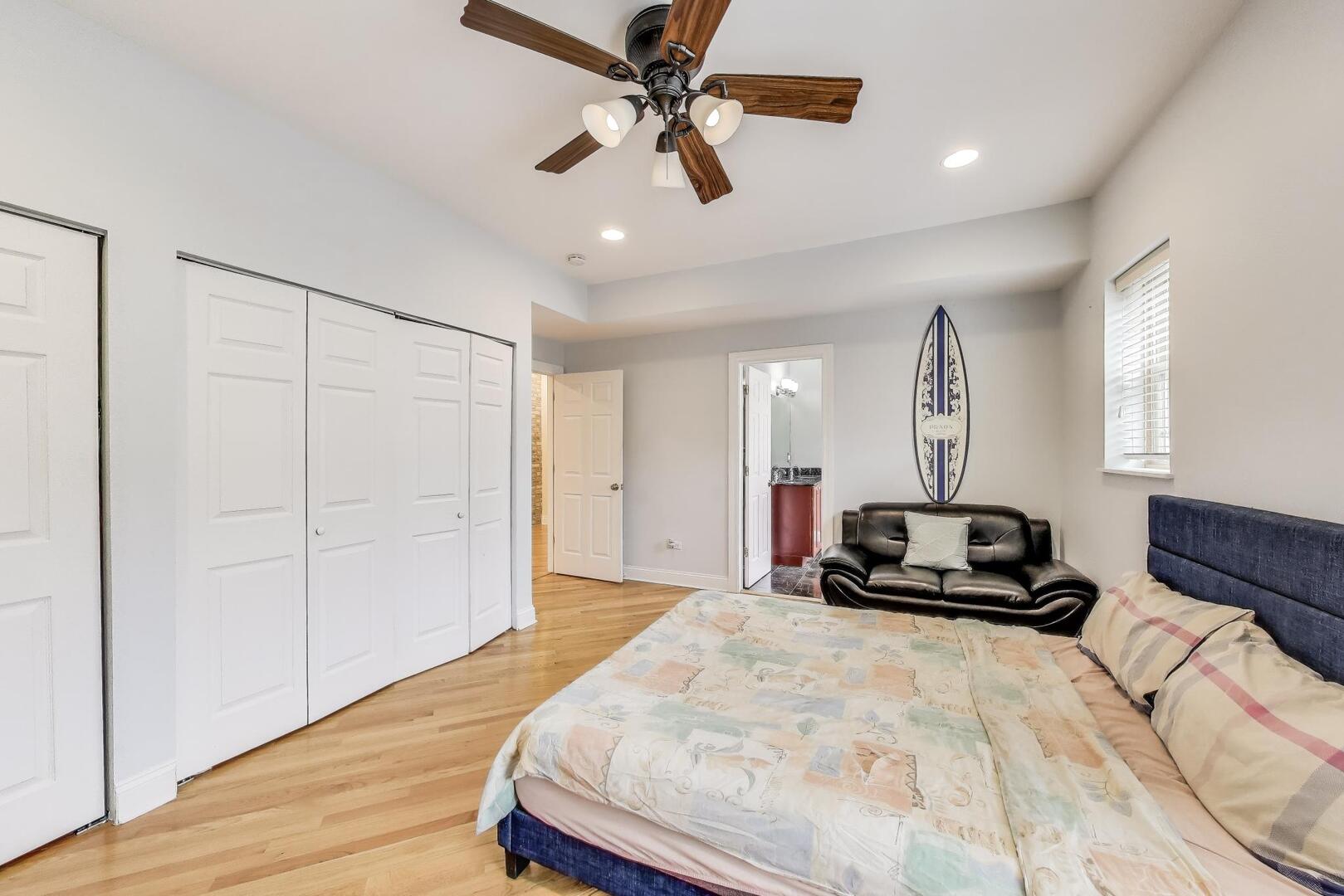 911 Maple Avenue, Unit 1N Evanston, IL 60202 - Photo 19 of 29 a bedroom with a bed and a chandelier