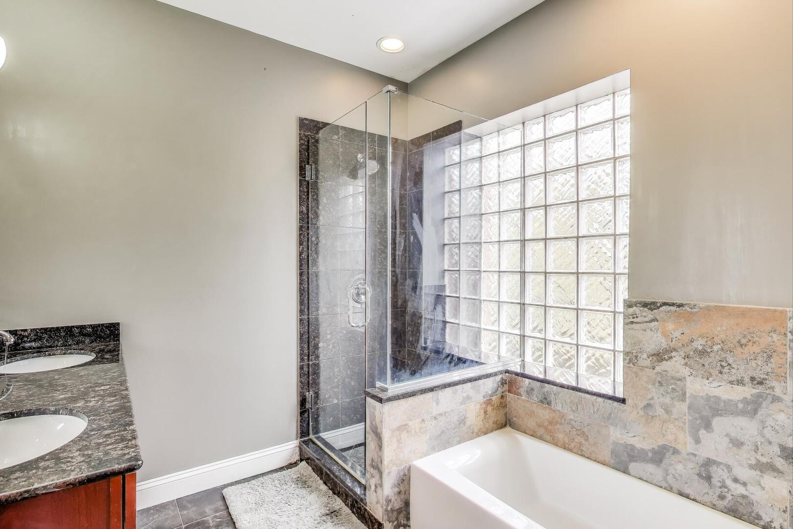 911 Maple Avenue, Unit 1N Evanston, IL 60202 - Photo 21 of 29 a bathroom with a granite countertop sink a toilet and shower