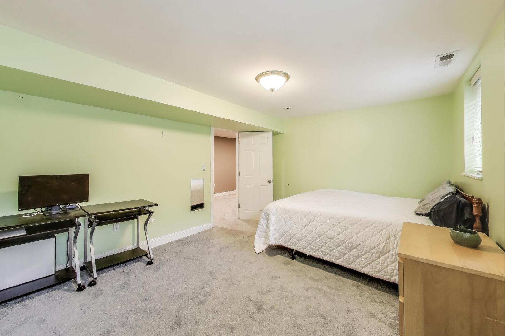 911 Maple Avenue, Unit 1N Evanston, IL 60202 - Photo 27 of 29 a bedroom with a bed and a flat screen tv