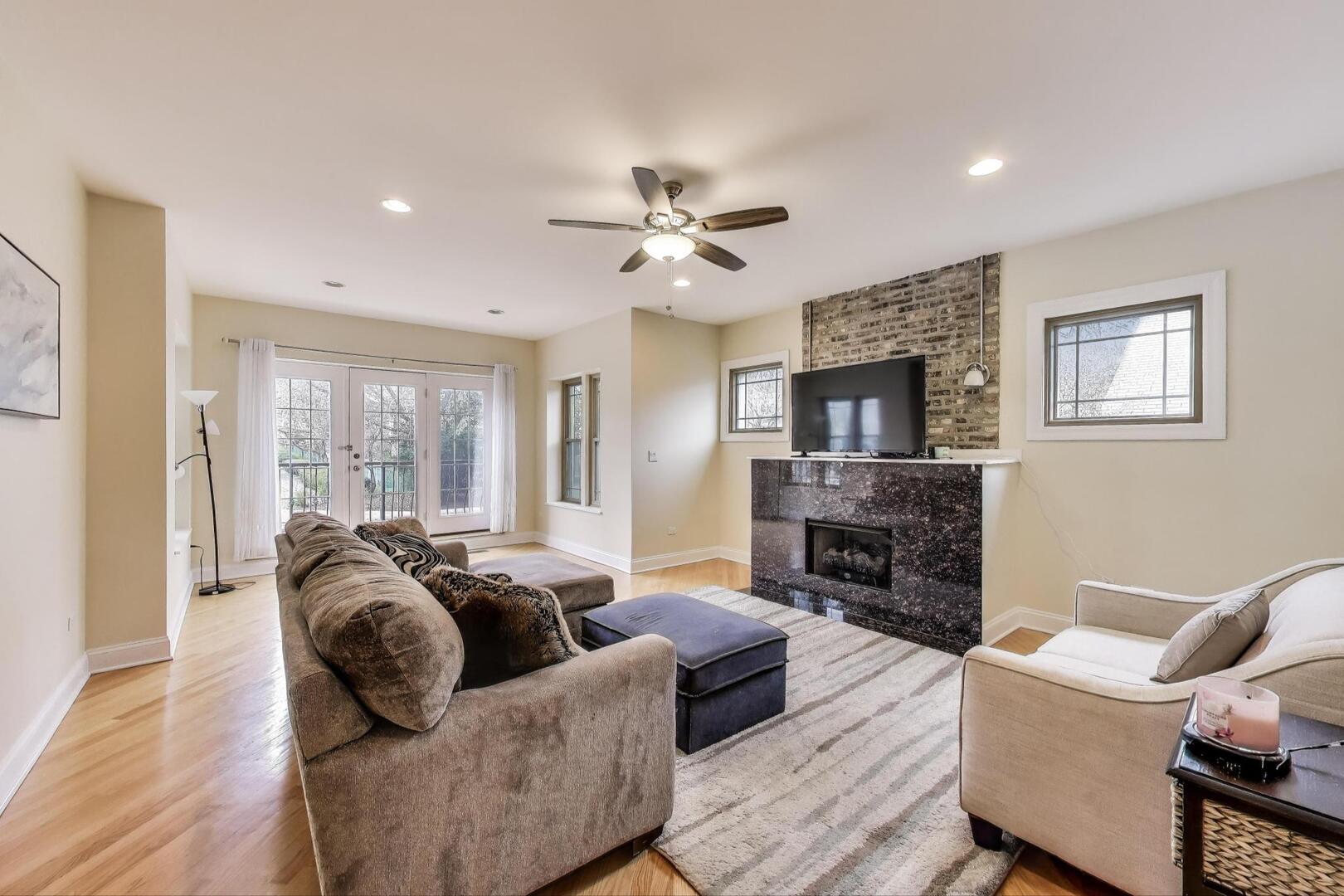 911 Maple Avenue, Unit 1N Evanston, IL 60202 - Photo 5 of 29 a living room with fireplace furniture and a flat screen tv
