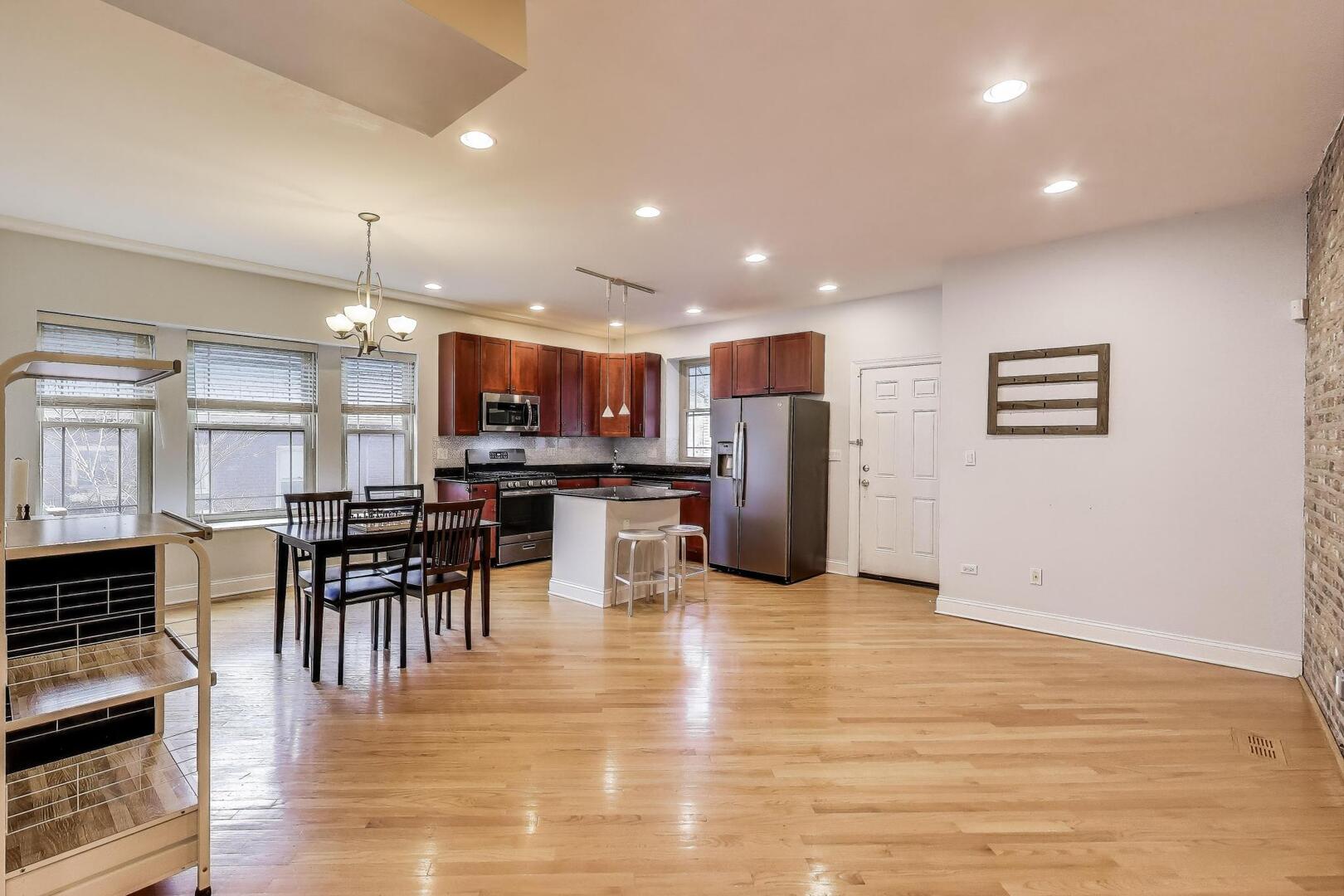 911 Maple Avenue, Unit 1N Evanston, IL 60202 - Photo 8 of 29 an open kitchen with kitchen island and stainless steel appliances
