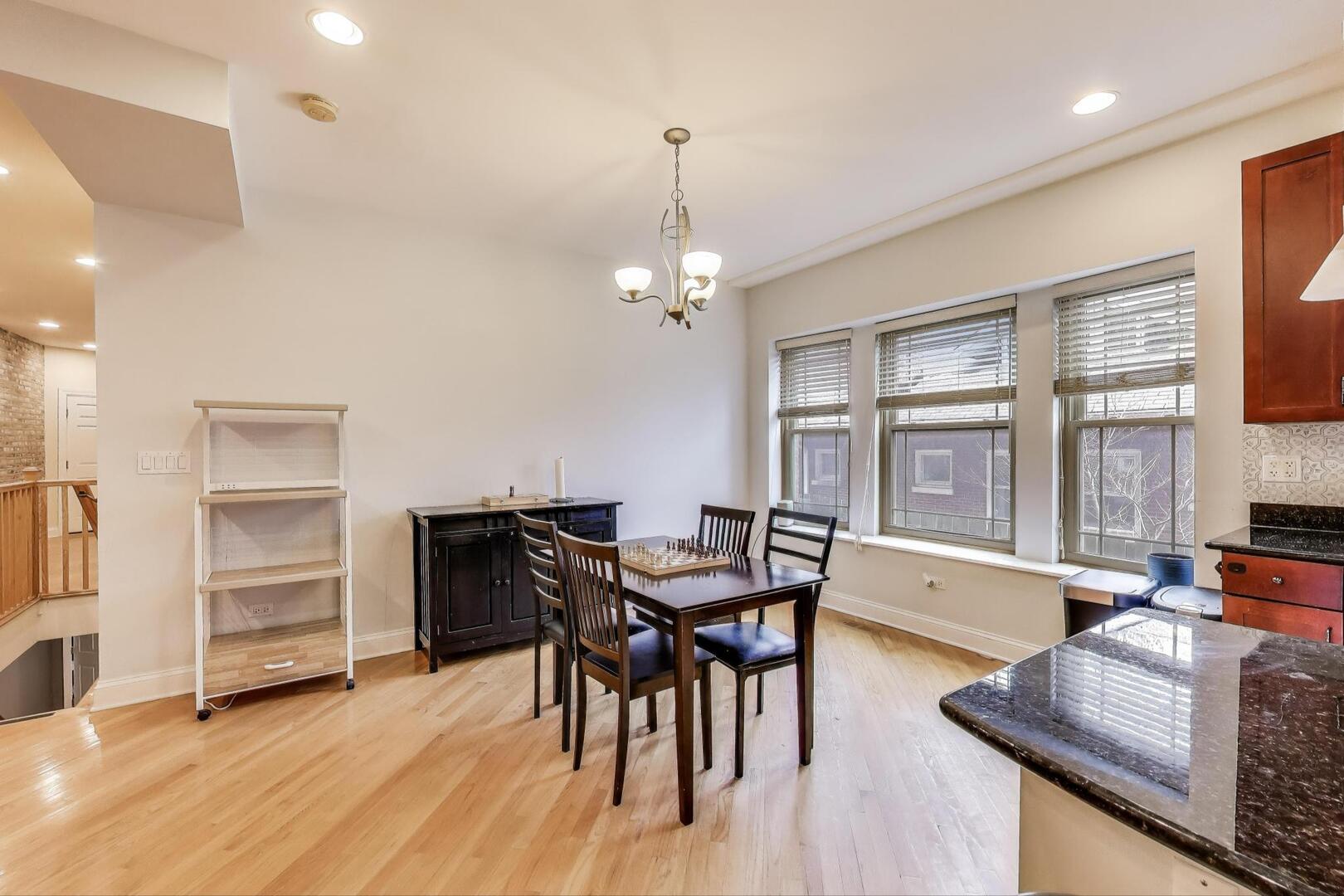 911 Maple Avenue, Unit 1N Evanston, IL 60202 - Photo 9 of 29 a view of a dining room with furniture window and wooden floor