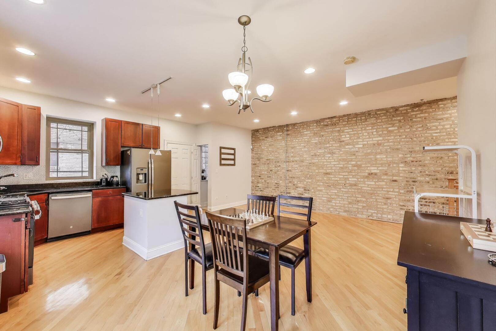 911 Maple Avenue, Unit 1N Evanston, IL 60202 - Photo 10 of 29 a view of a dining room with furniture and wooden floor