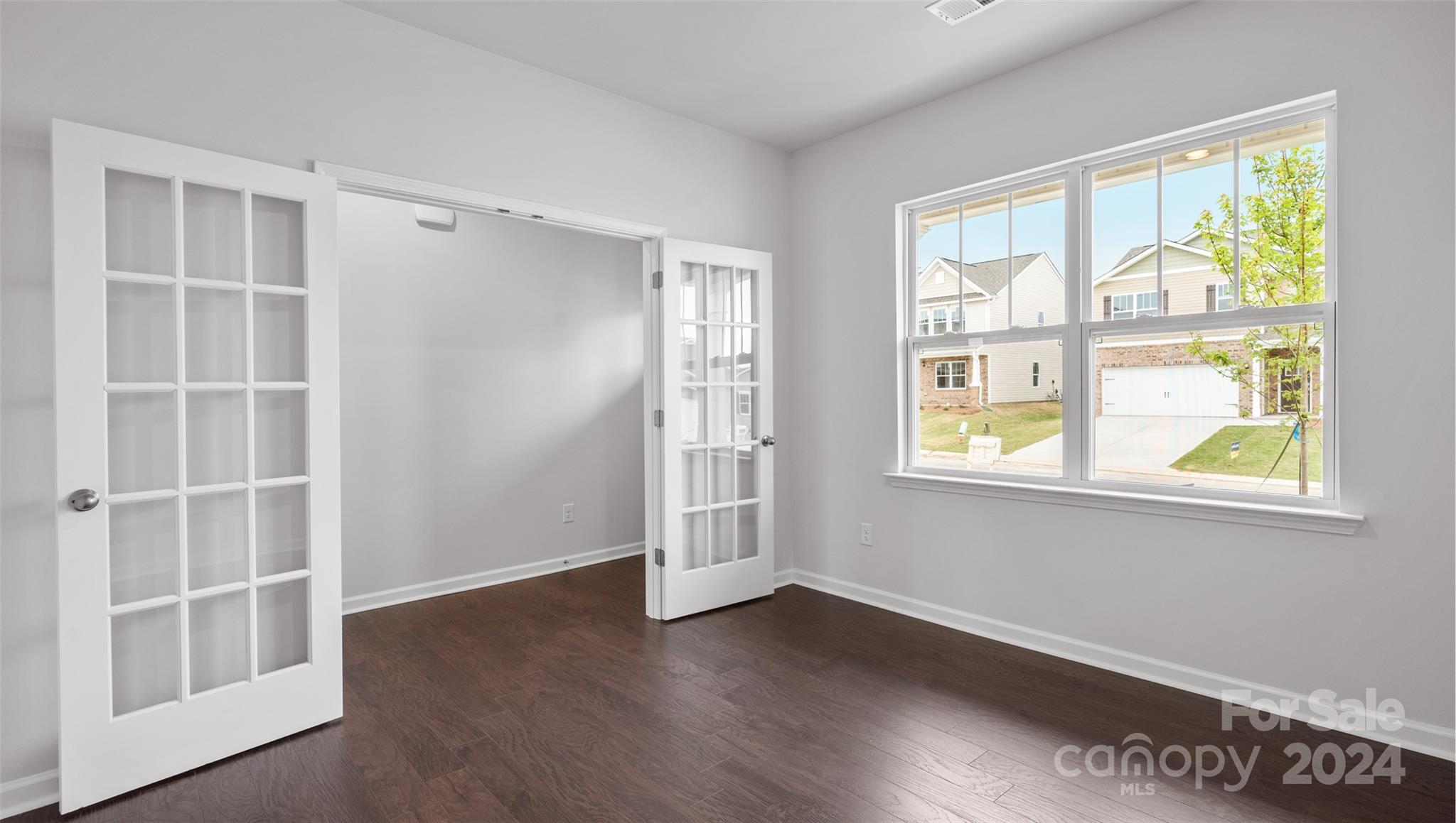 83 Callie River Clyde, NC 28721 - Photo 12 of 26 a view of an empty room with a window and wooden floor