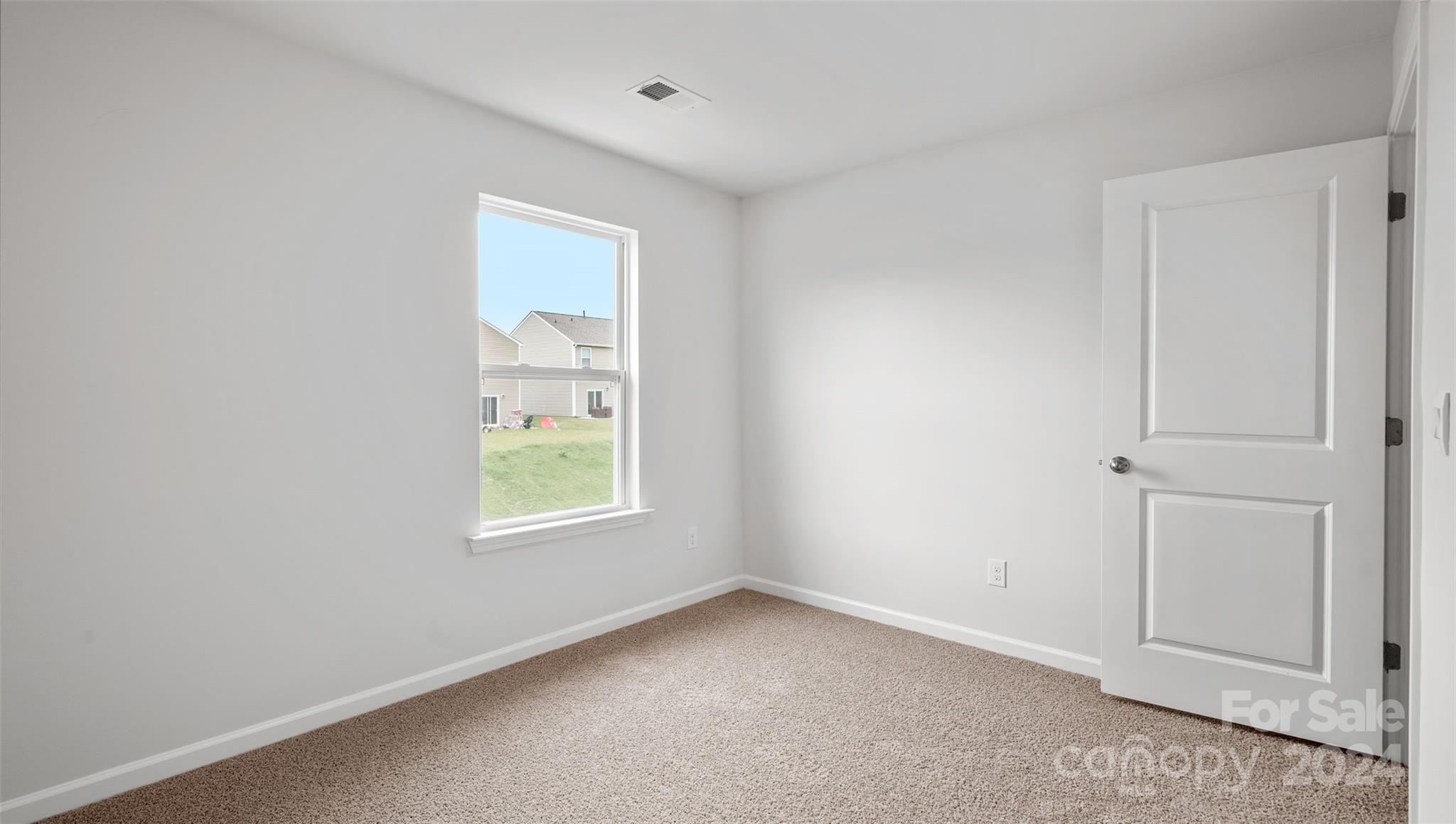 83 Callie River Clyde, NC 28721 - Photo 17 of 26 an empty room with windows and closet