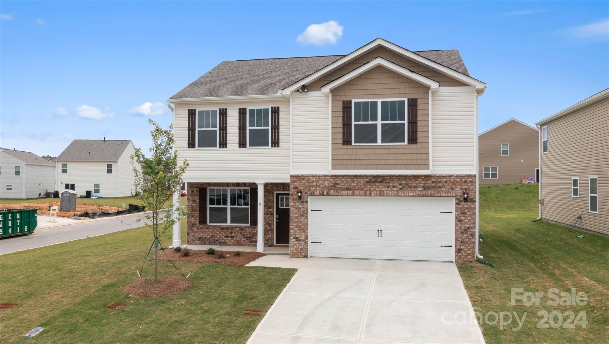 83 Callie River Clyde, NC 28721 - Photo 2 of 26 a front view of a house with a yard and garage