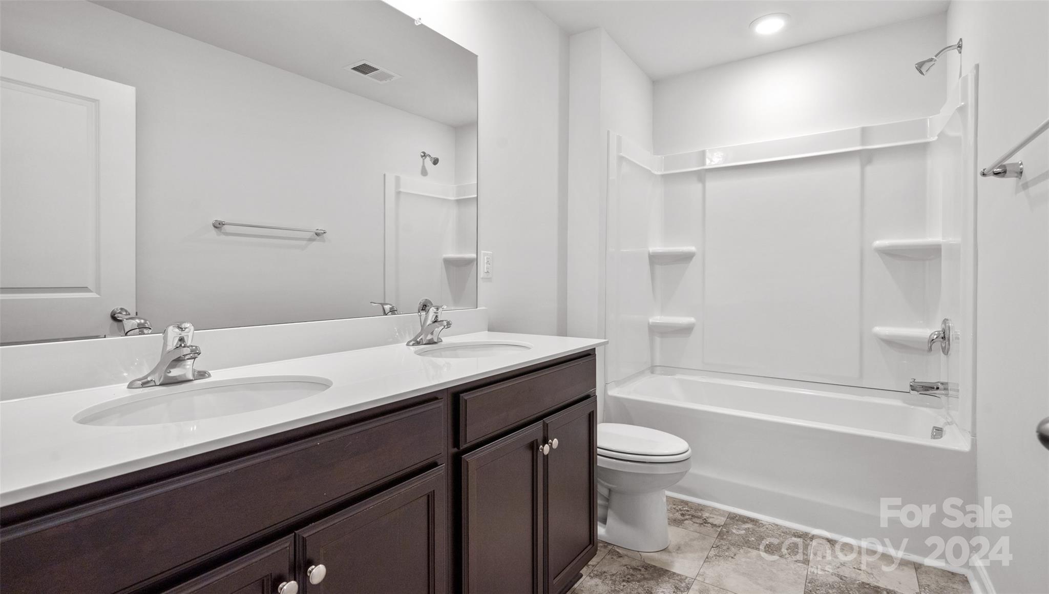 83 Callie River Clyde, NC 28721 - Photo 24 of 26 a bathroom with a sink a toilet and shower