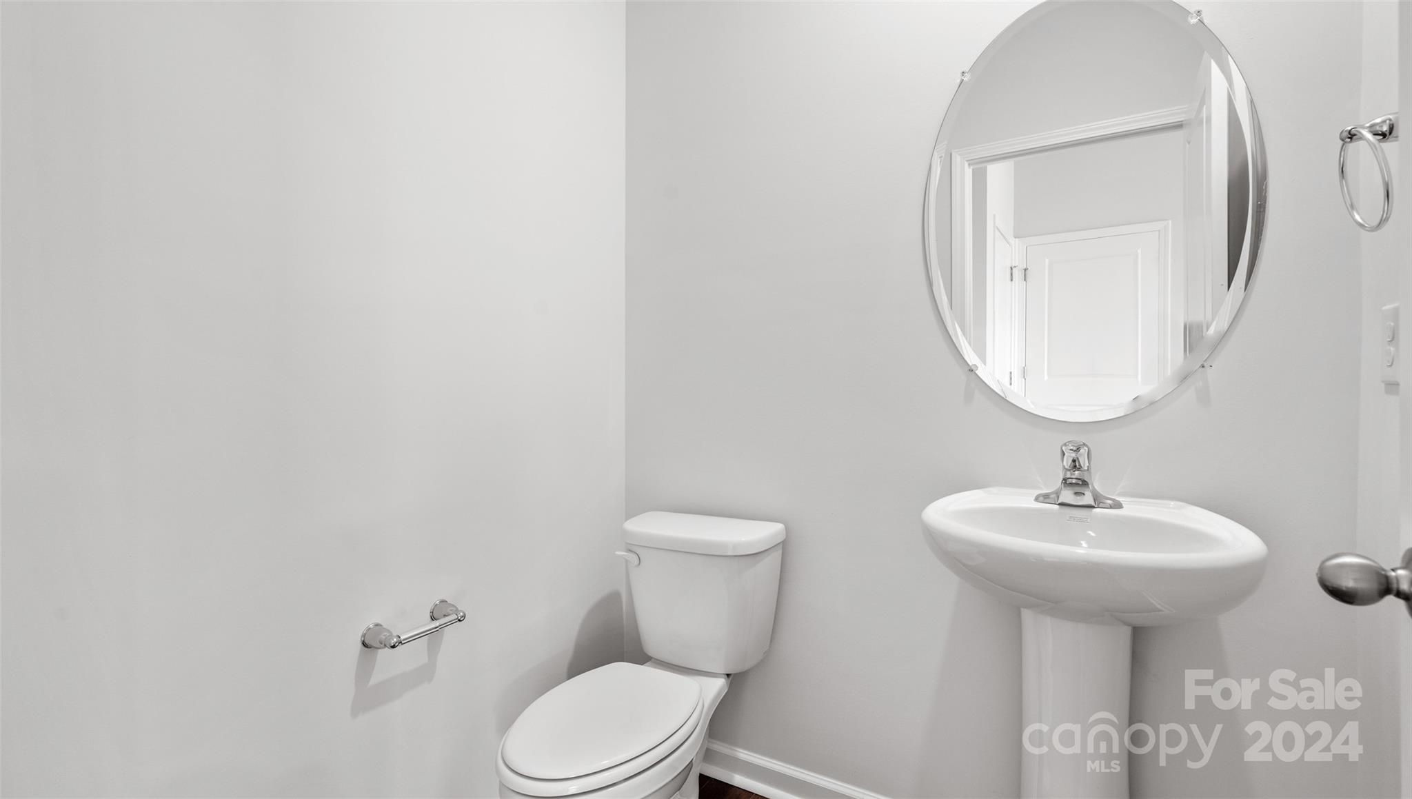 83 Callie River Clyde, NC 28721 - Photo 25 of 26 a bathroom with a toilet sink and mirror