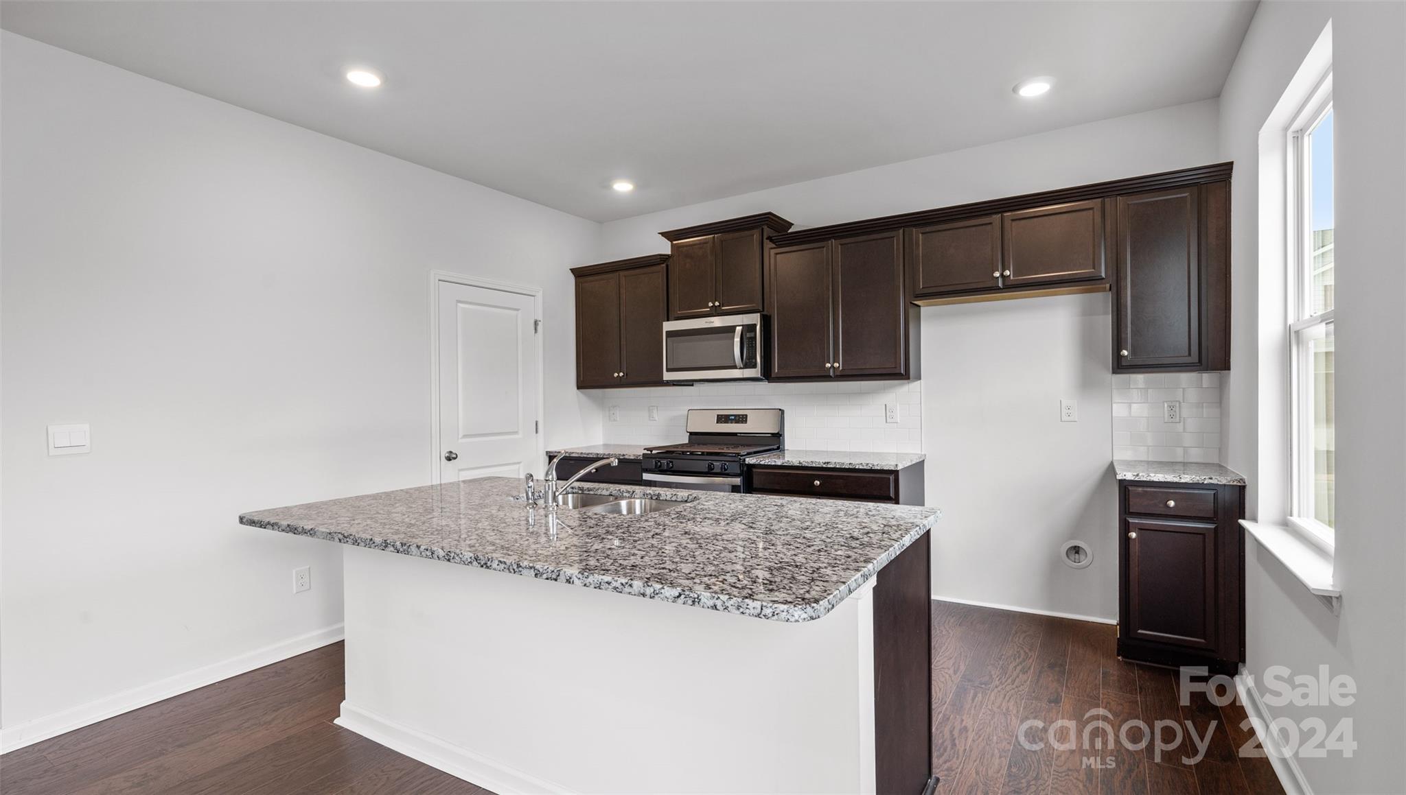 83 Callie River Clyde, NC 28721 - Photo 26 of 26 a kitchen with granite countertop a sink and stainless steel appliances