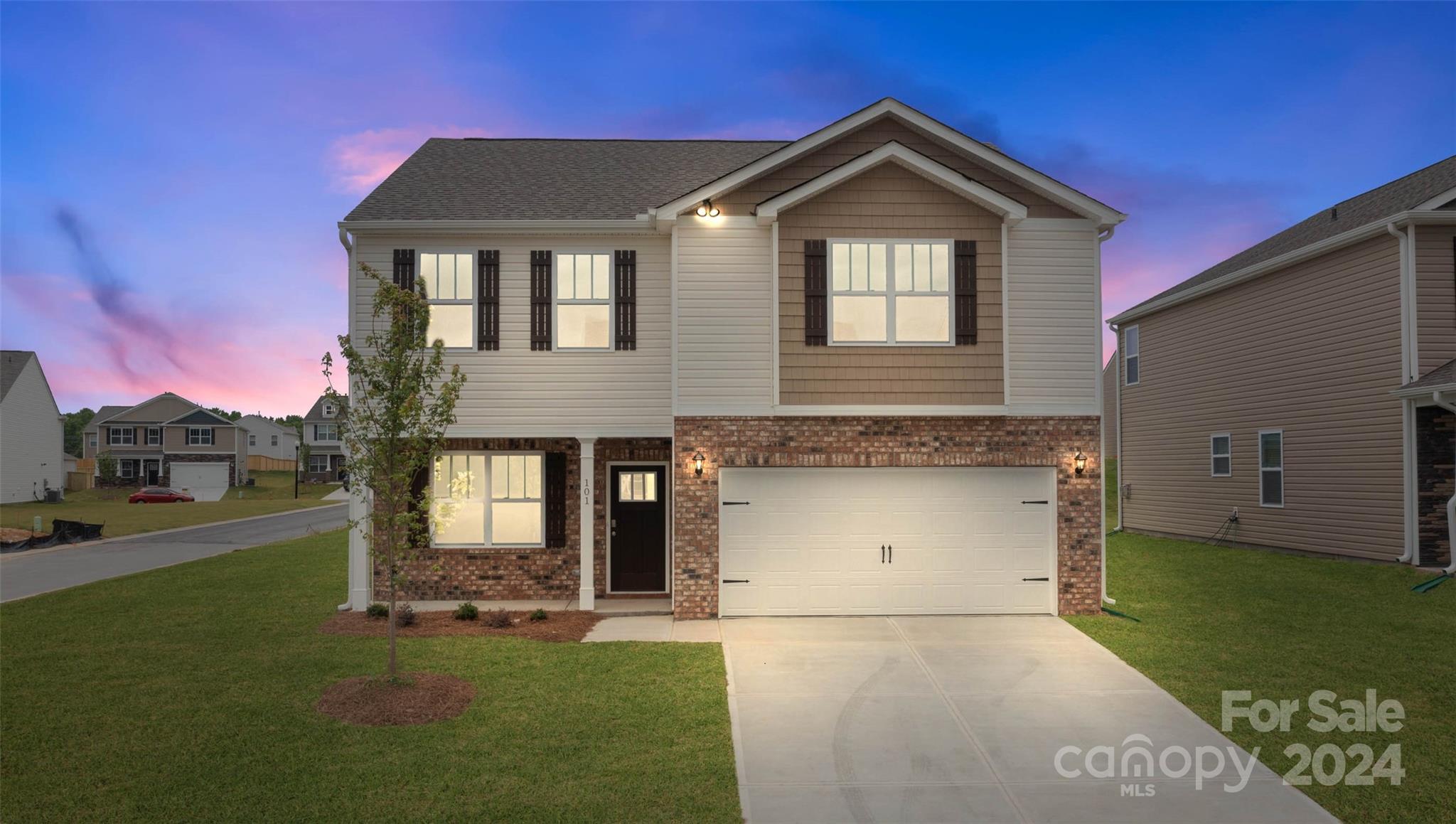 83 Callie River Clyde, NC 28721 - Photo 8 of 26 a front view of a house with a yard and garage