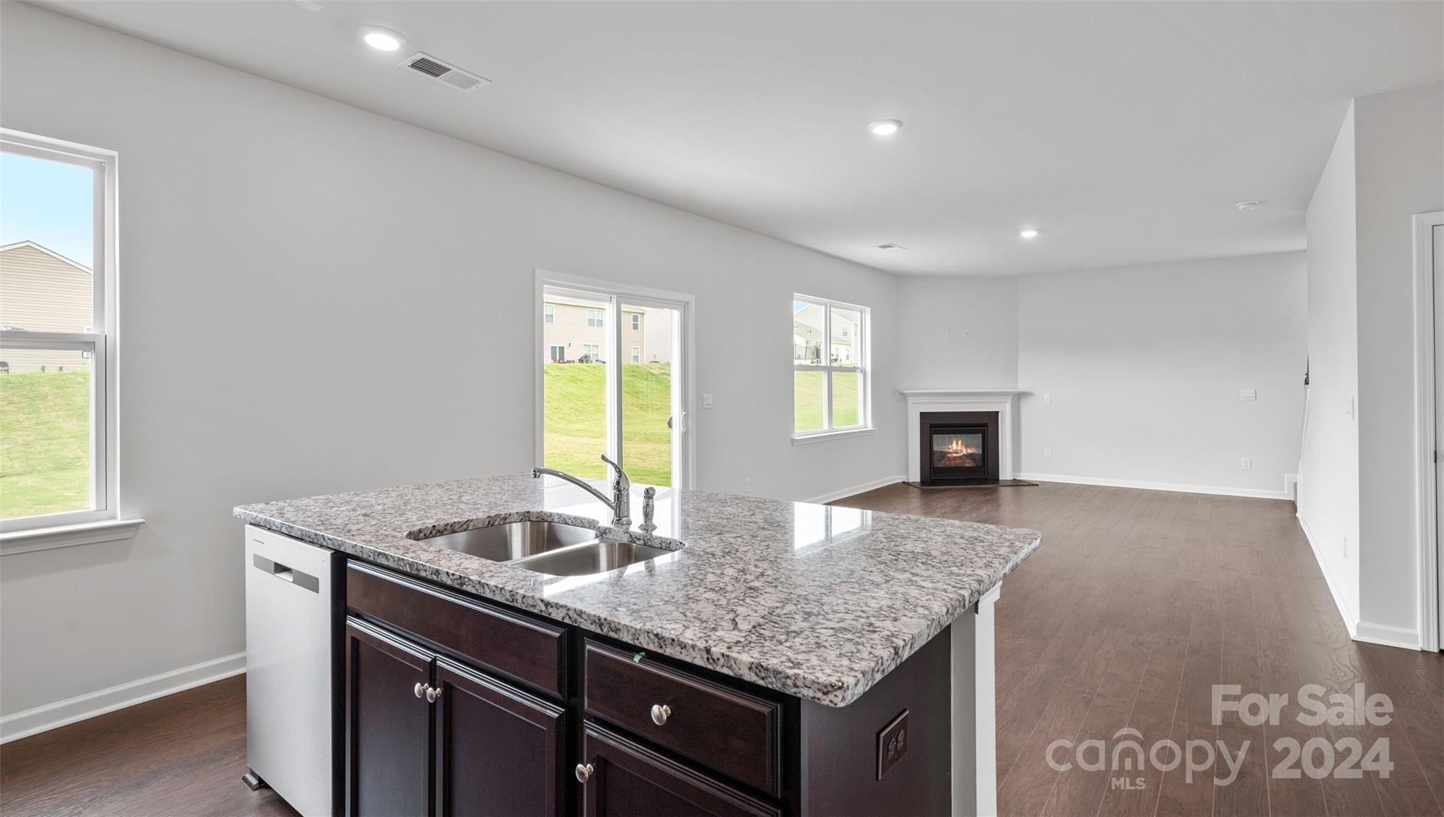 83 Callie River Clyde, NC 28721 - Photo 10 of 26 a kitchen with granite countertop kitchen island a sink appliances and a counter space