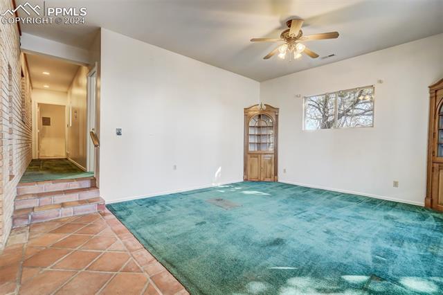 23555 Murphy Road Calhan, CO 80808 - Photo 9 of 49 Carpeted spare room with ceiling fan