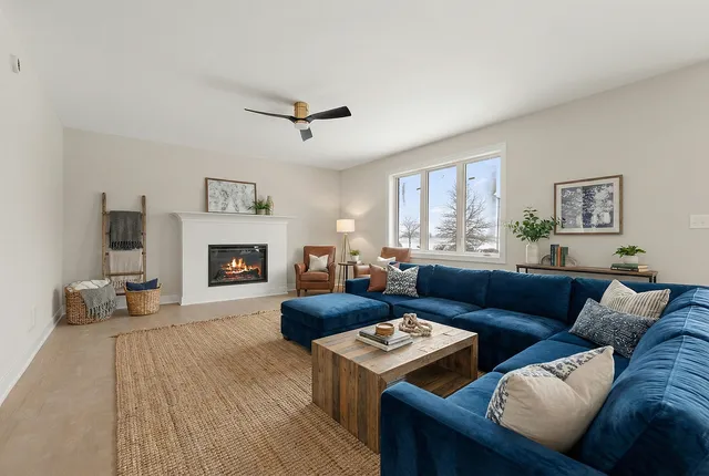 a living room with furniture and a fireplace