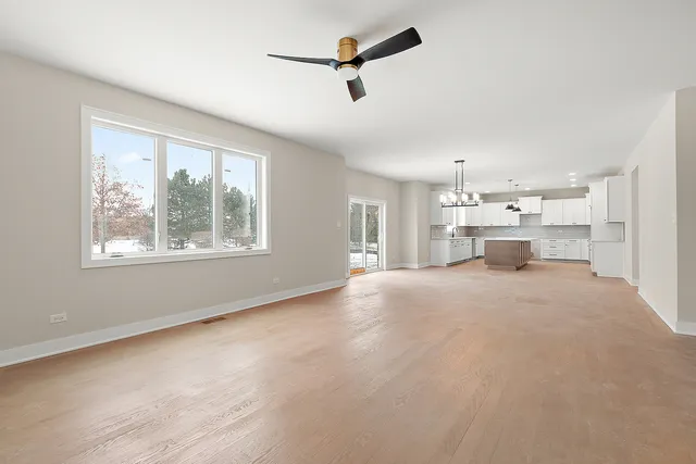 a view of empty room with a kitchen
