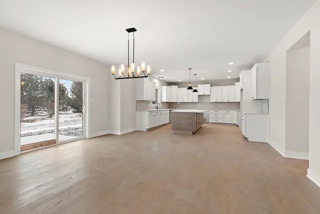 a view of a kitchen with refrigerator and windows