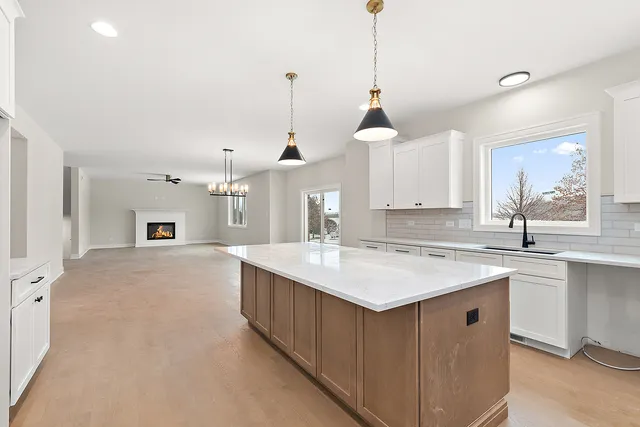 a kitchen with a sink stove and a center island