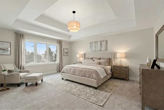 a spacious bedroom with a bed and a large window