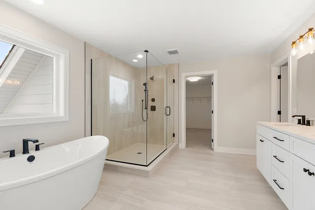 a bathroom with a double vanity sink toilet and shower
