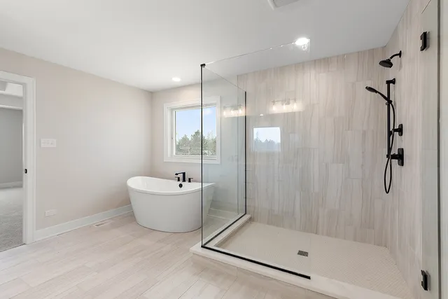 a bathroom with a tub and a shower