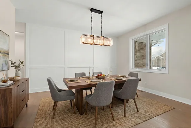 a view of a dining room with a table and chairs