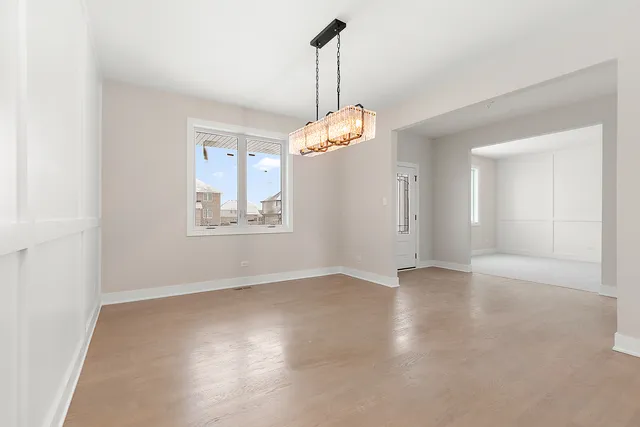 an empty room with windows and entrance