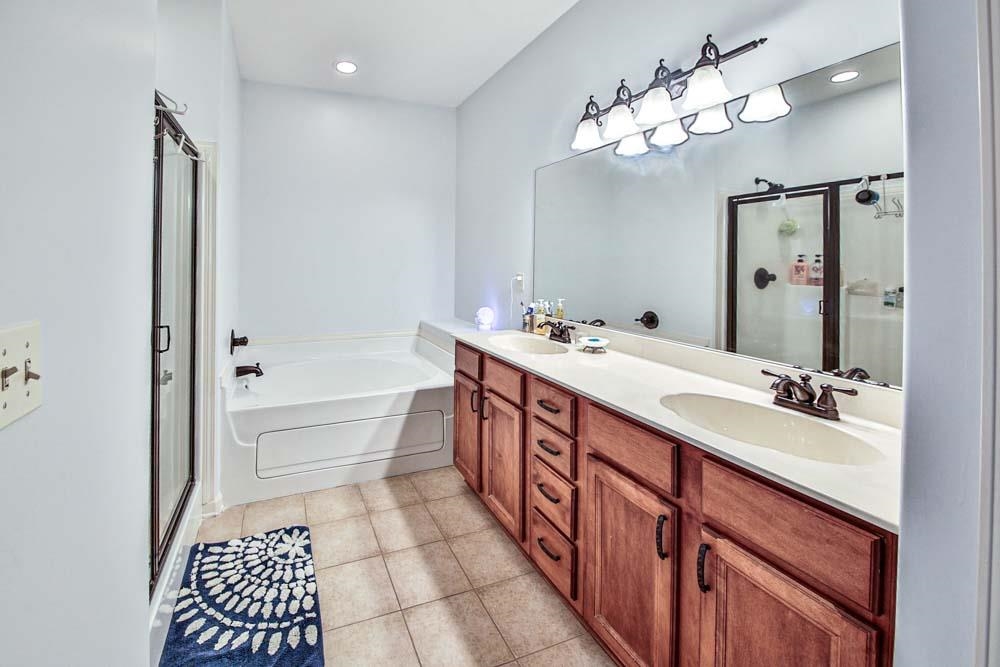 82 Ridgetop Cove Atoka, TN 38004 - Photo 17 of 31 Bathroom with a shower stall, a bath, light tile patterned floors, double vanity, and recessed lighting