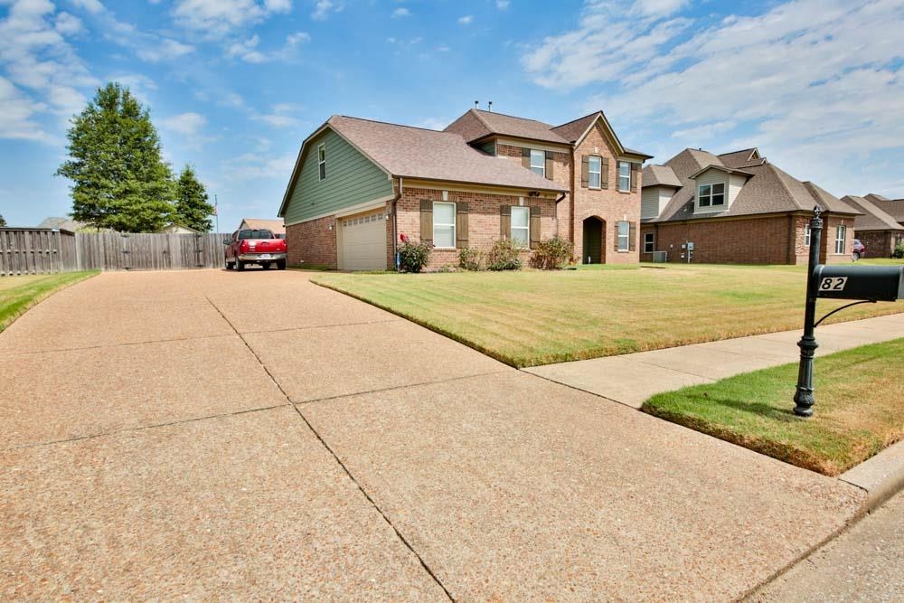 82 Ridgetop Cove Atoka, TN 38004 - Photo 2 of 31 Traditional-style home with brick siding, a garage, and concrete driveway