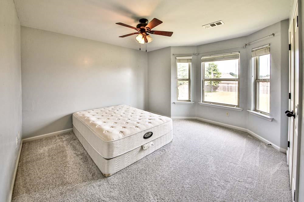 82 Ridgetop Cove Atoka, TN 38004 - Photo 23 of 31 Carpeted bedroom featuring ceiling fan and baseboards