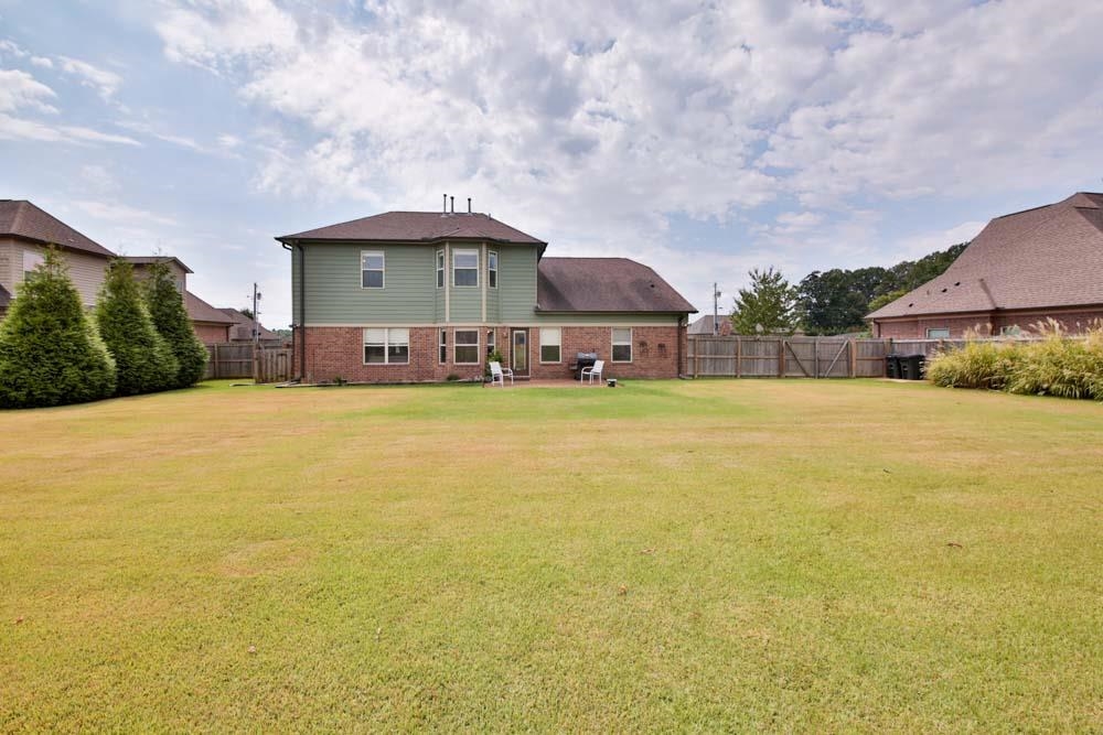 82 Ridgetop Cove Atoka, TN 38004 - Photo 31 of 31 Rear view of house with brick siding, a fenced backyard, and a patio
