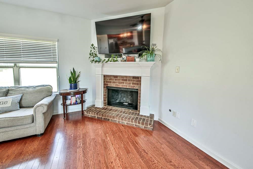 82 Ridgetop Cove Atoka, TN 38004 - Photo 6 of 31 Living area featuring wood finished floors and a fireplace