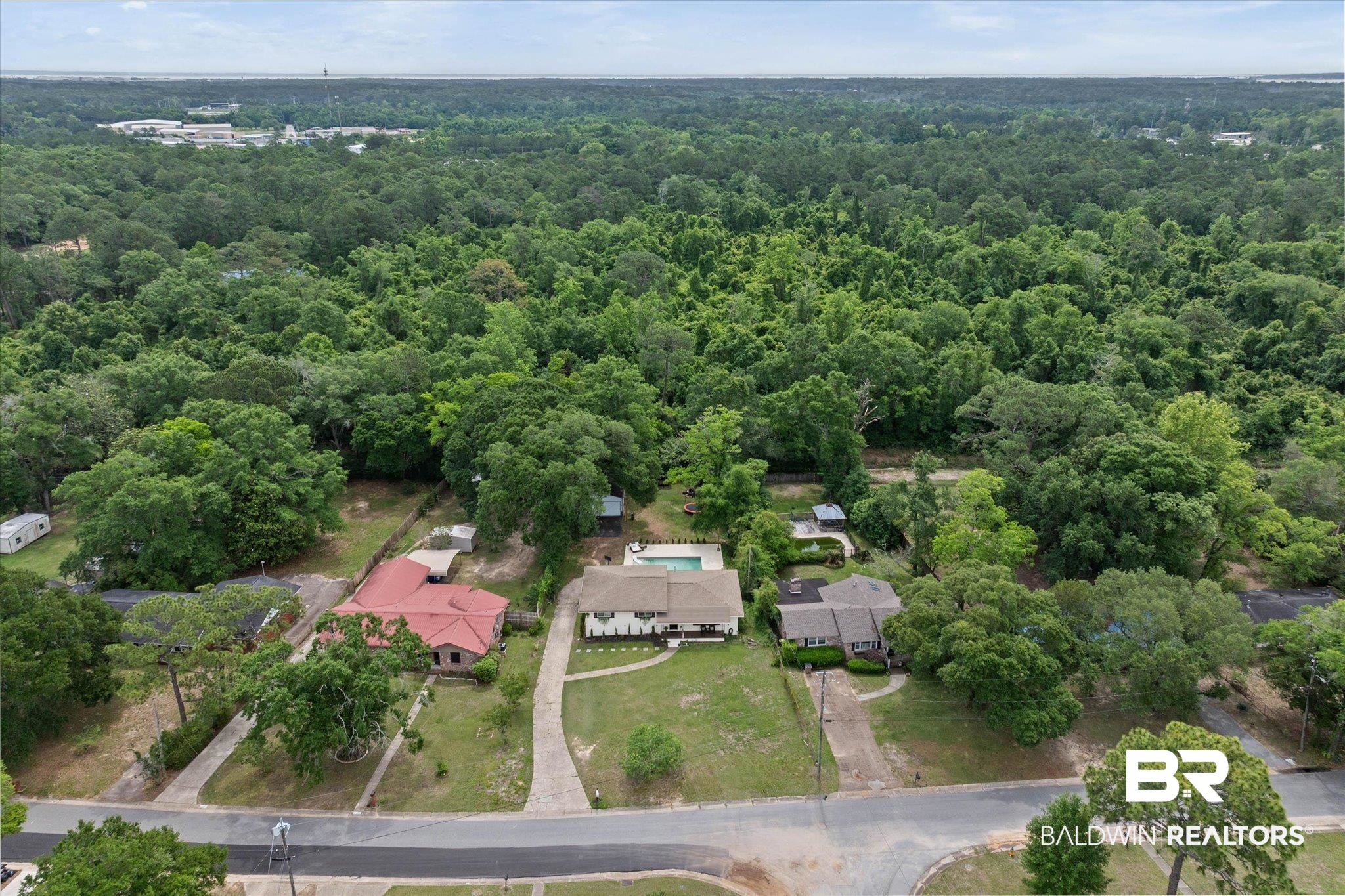 4213 Shan Drive East Mobile, AL 36693 - Photo 34 of 35 Aerial view of a residential property with a detached home, a private swimming pool, and a paved driveway